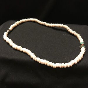 Woman’s coral necklace.